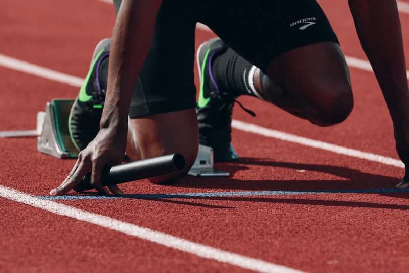 Athlete waiting to start sprinting at a start line.